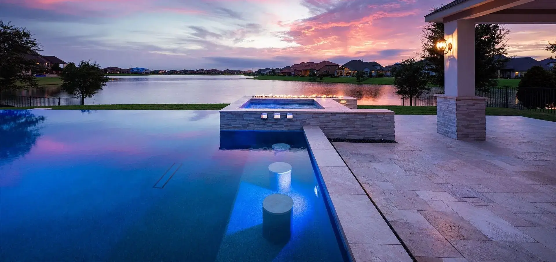 Infinity-edge custom pool at sunset overlooking the Texas Hill Country, designed by Longhorn Pools in Southwest Austin.