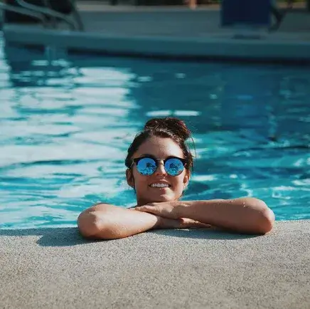 Person relaxing by a pool built by Longhorn Pools in Austin, TX.